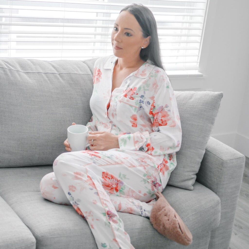 woman stting on couch wearing pajamas